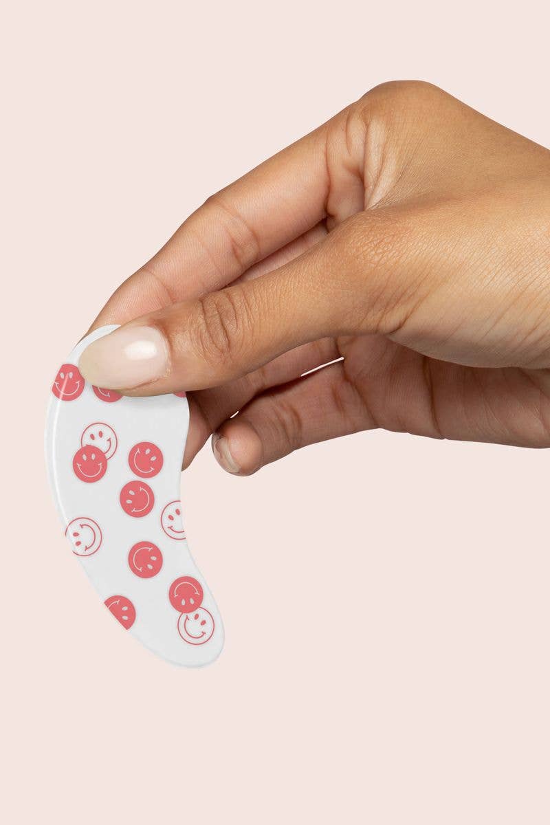 Modern Grace Happy Vibes reusable under-eye patches for skincare, shown on the product packaging with patches applied under eyes.
