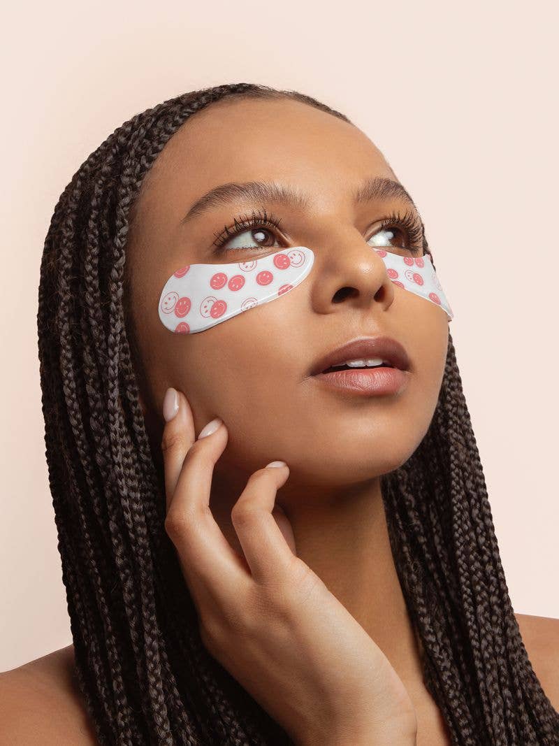 Modern Grace Happy Vibes reusable under-eye patches for skincare, showing the patches on a person's under-eye area.