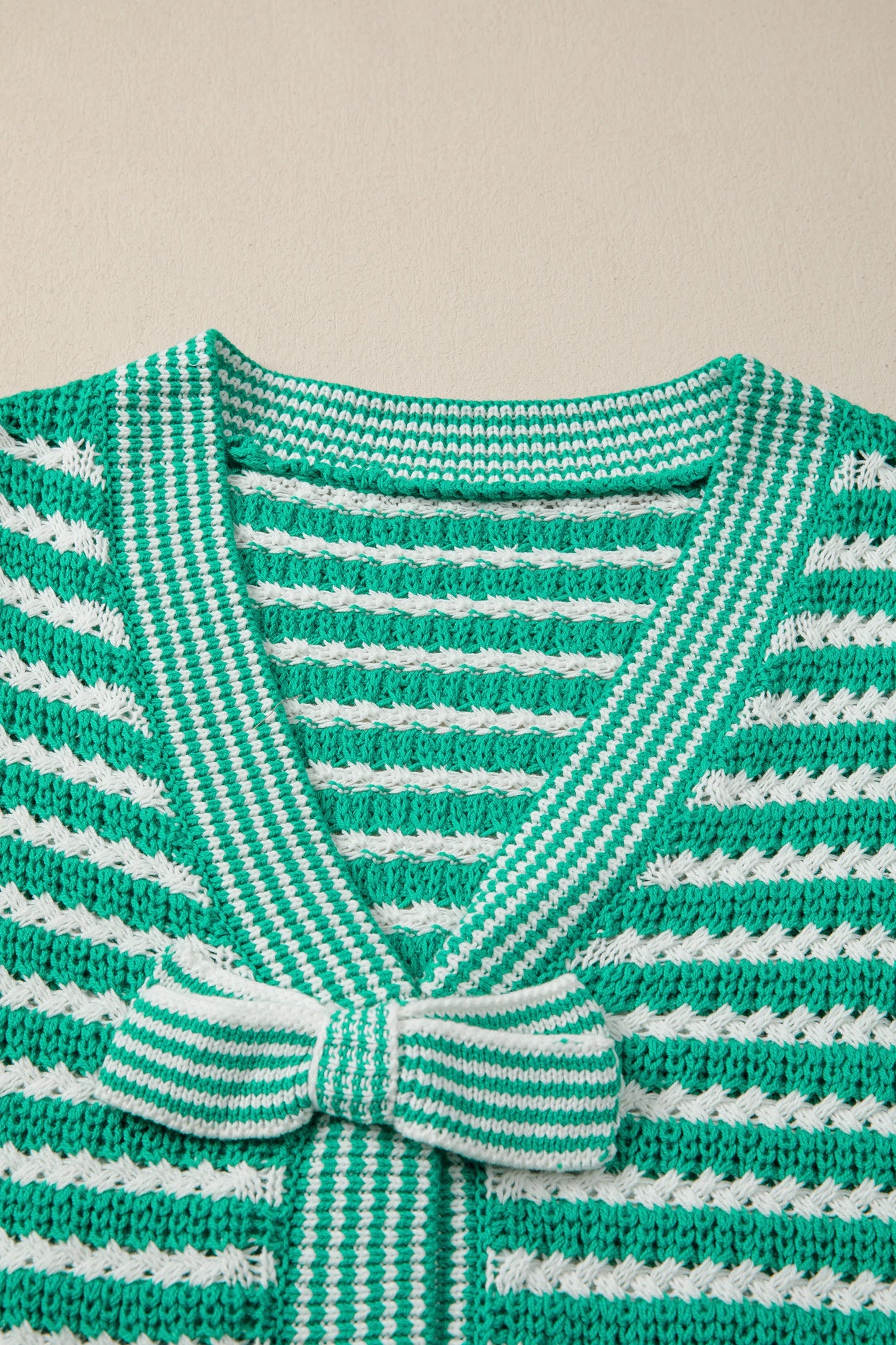 Green stripe short sleeve V-neck sweater with bow knot detail from Modern Grace, showcasing a stylish, casual knit top.