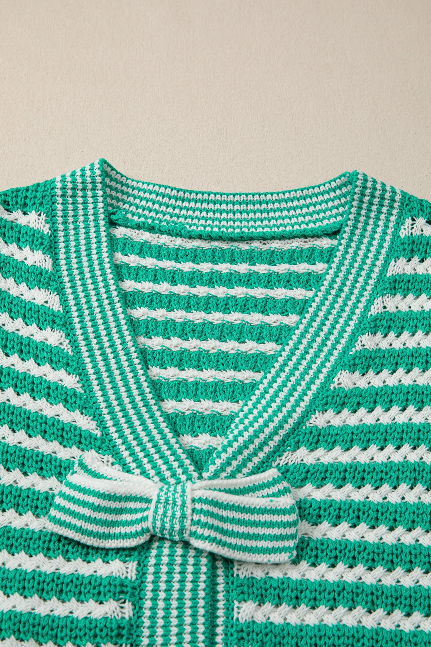 Green stripe short sleeve V-neck sweater with bow knot detail from Modern Grace, showcasing a stylish, casual knit top.