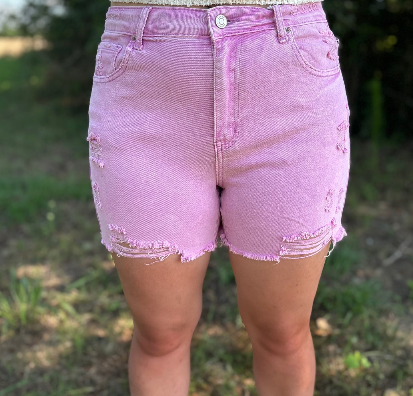 Mauve distressed raw hem shorts by Modern Grace, featuring a casual fit and frayed edges, perfect for summer wear.