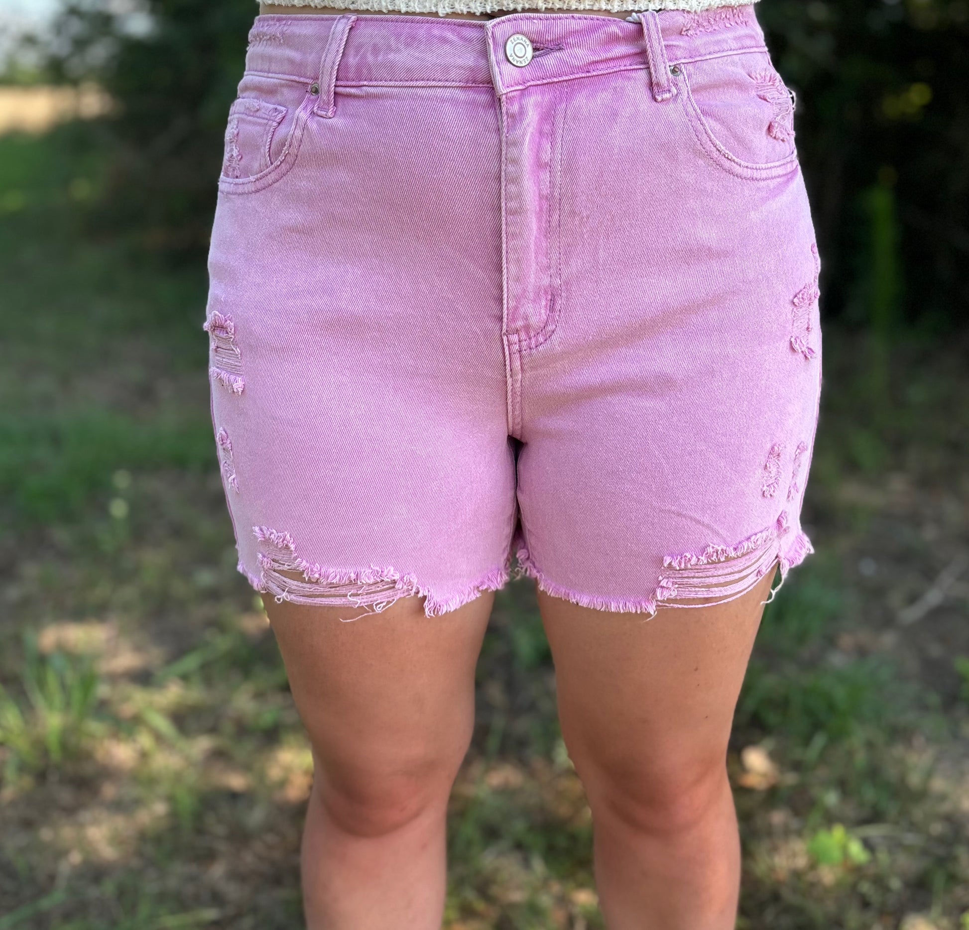 Mauve distressed raw hem shorts by Modern Grace, featuring a casual fit and frayed edges, perfect for summer wear.