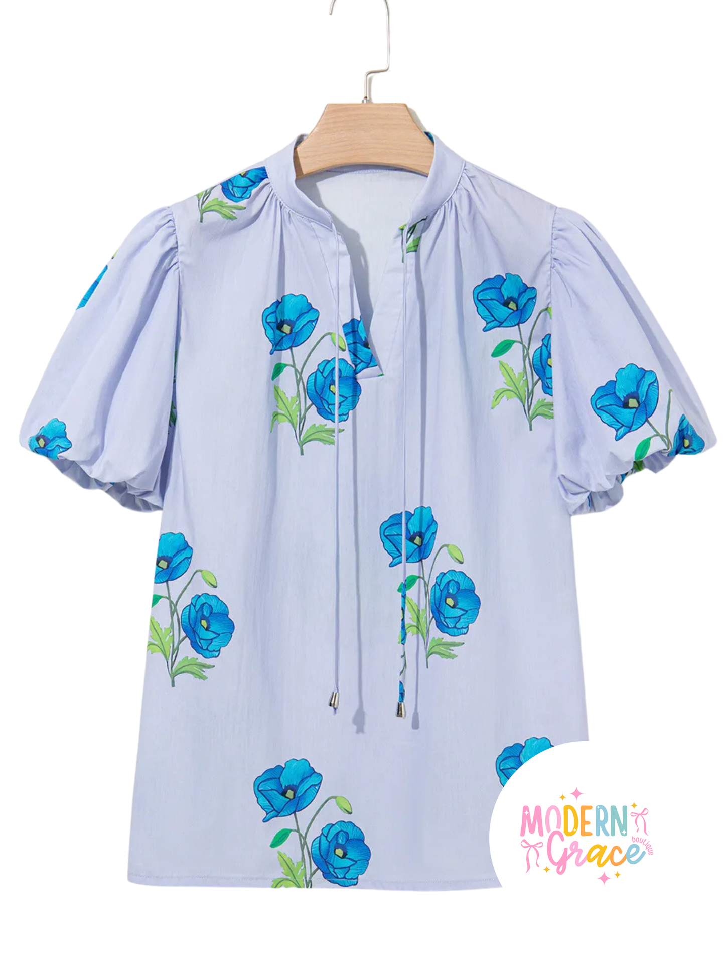 Sky blue floral print blouse by Modern Grace featuring tie neck, split neckline, and short puff sleeves.