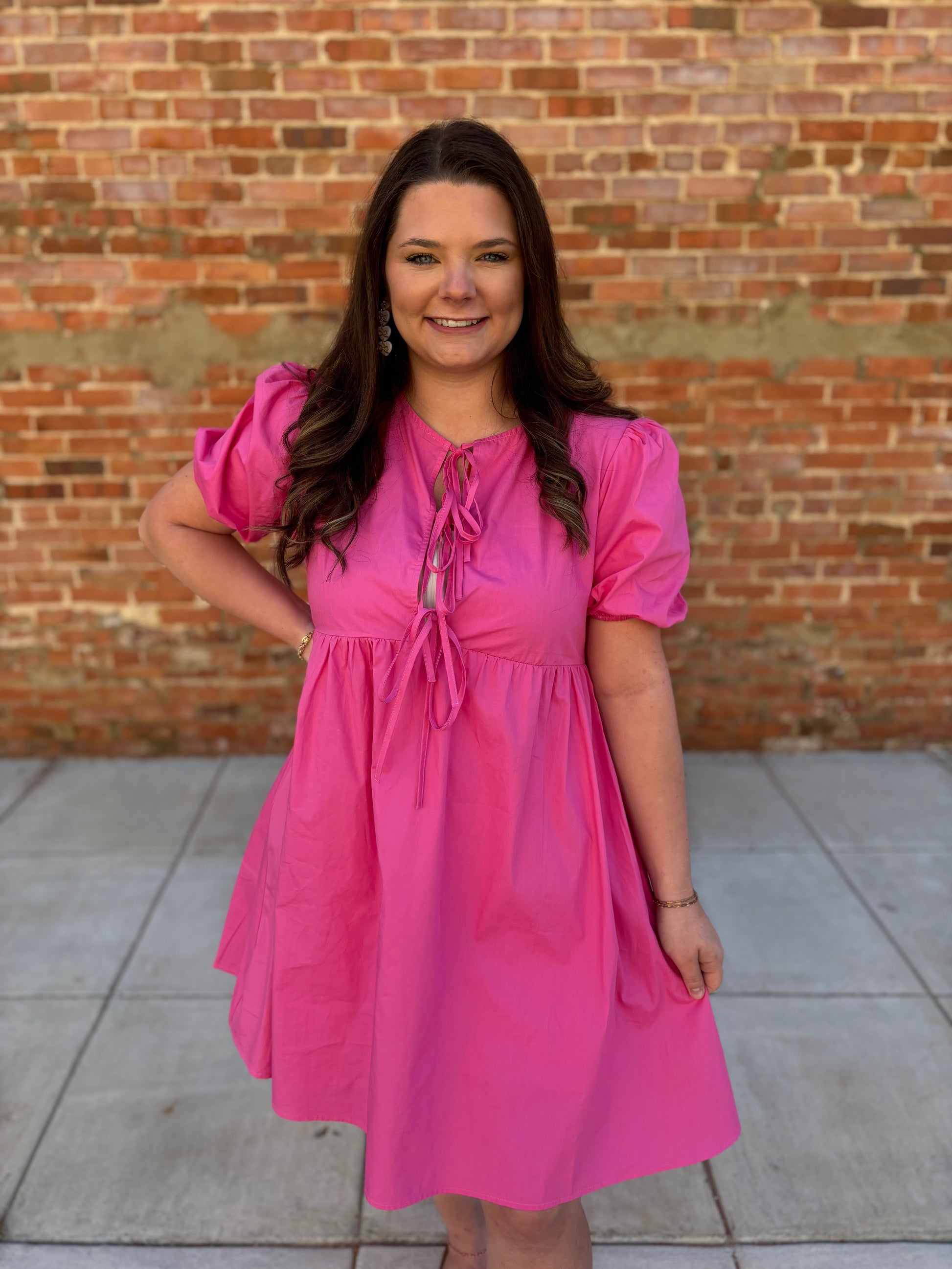 Solid pink puff sleeve bow dress by Modern Grace, featuring a feminine design with puffed sleeves and a bow detail.