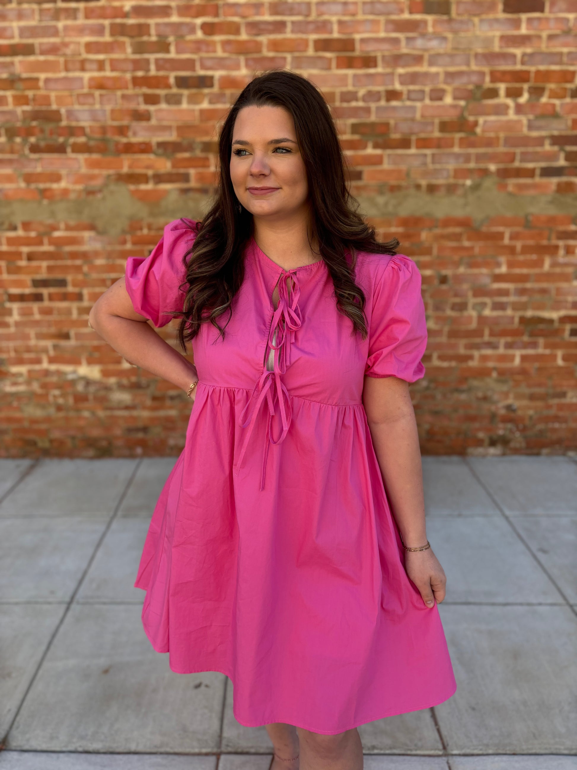 Solid pink puff sleeve bow dress by Modern Grace, featuring a feminine design with puff sleeves and a bow detail.