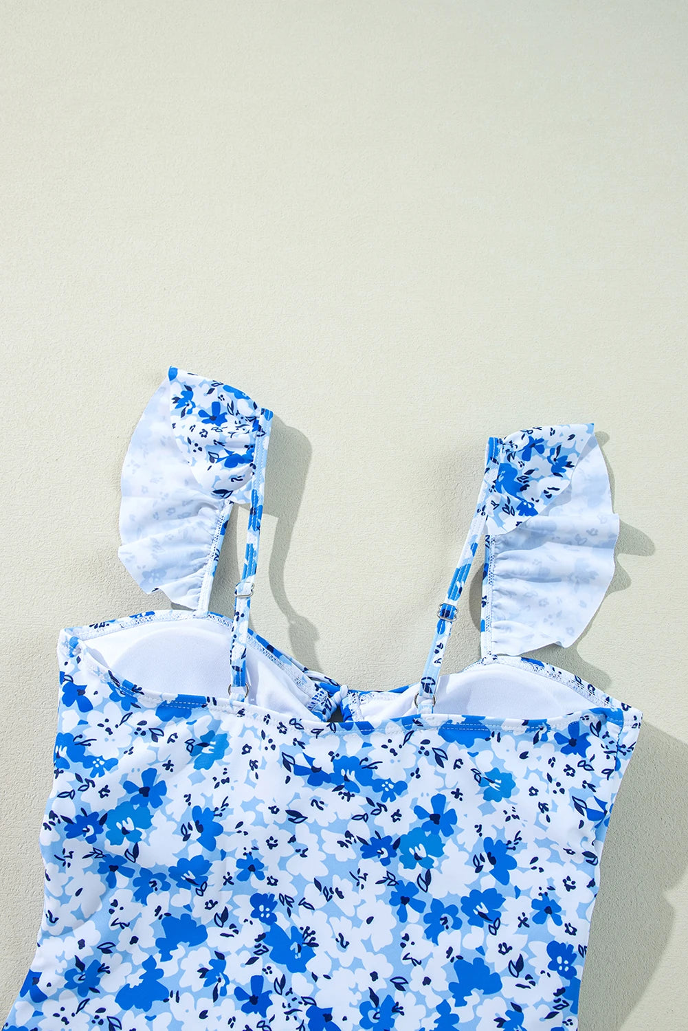 Blue floral lace-up hollow-out one-piece swimsuit by Modern Grace, showcasing a stylish design with cut-out details and vibrant floral pattern.