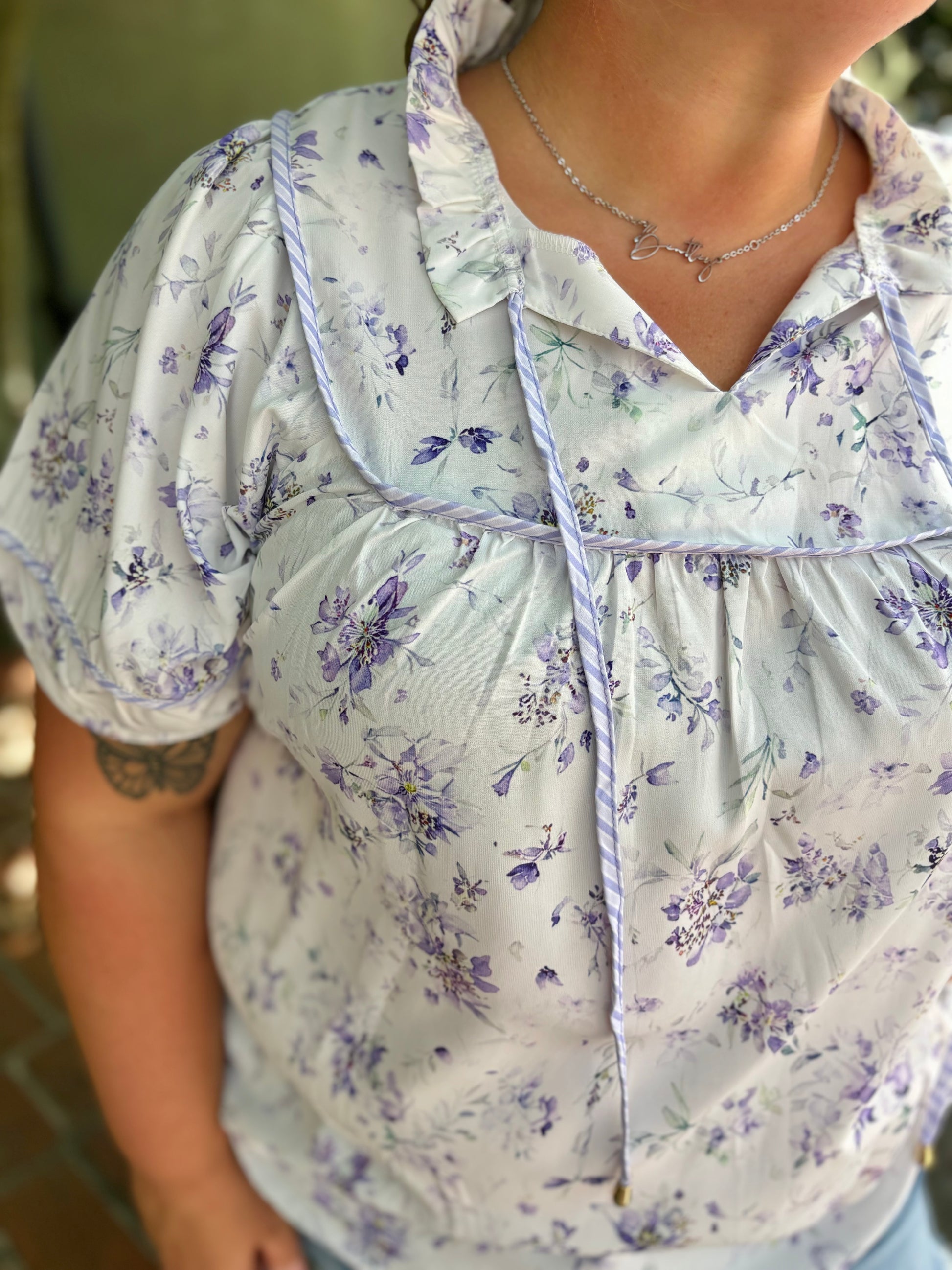 Modern Grace curvy purple floral top with long sleeves and ruffled neckline, stylish and comfortable for casual wear.