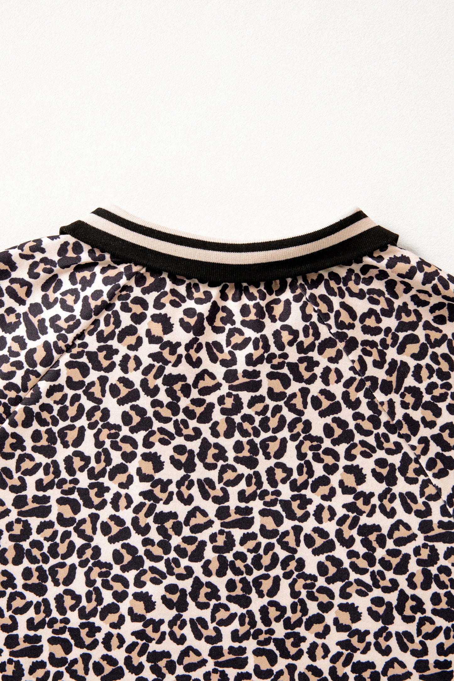 Modern Grace brown leopard print half zip blouse with striped trim and patchwork short sleeves, casual stylish top.