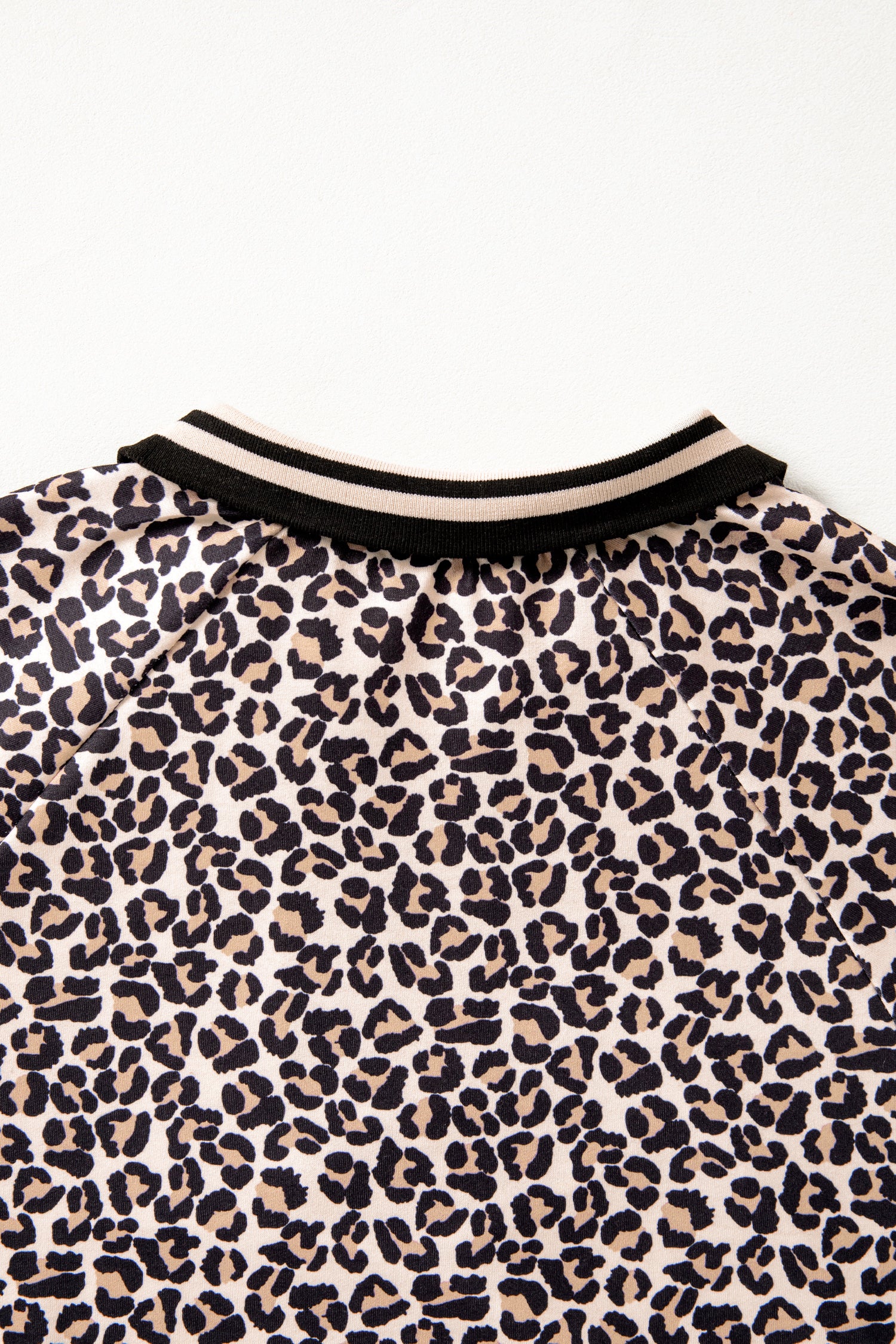 Modern Grace brown leopard print half zip blouse with striped trim and patchwork short sleeves, casual stylish top.