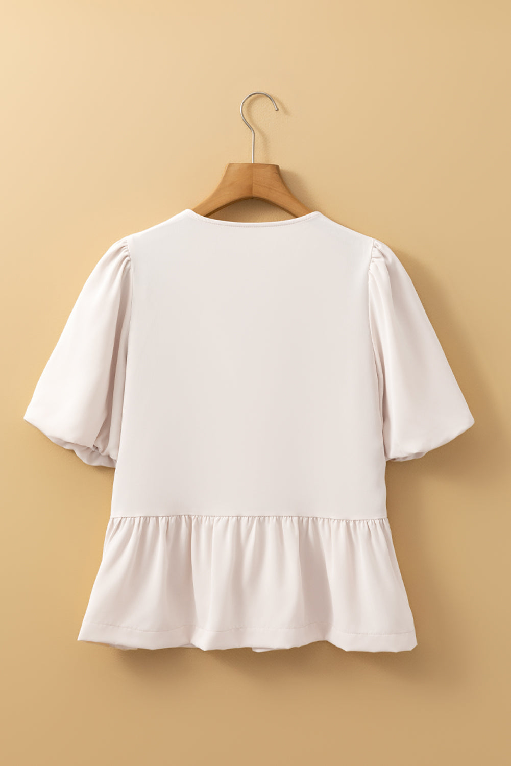 Modern Grace Off White blouse with bow tie, short puff sleeves, and ruffle hem, stylish top for casual or dressy wear.
