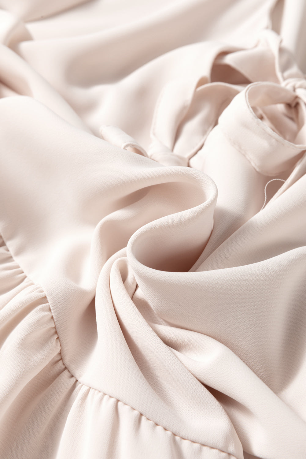 Off White Bow Tie Short Puff Sleeve Ruffle Hem Blouse by Modern Grace, lightweight polyester, featuring a bow tie neckline and puff sleeves.