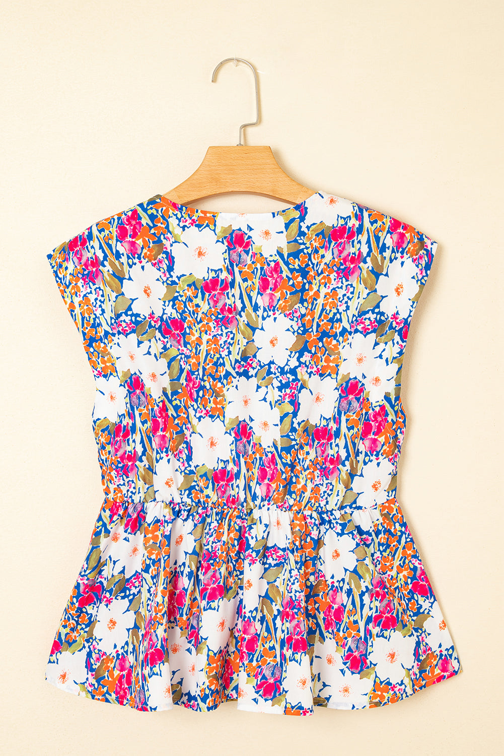 Modern Grace floral print sleeveless peplum blouse with bow applique, slit sleeves, and floral design, perfect for stylish summer wear.