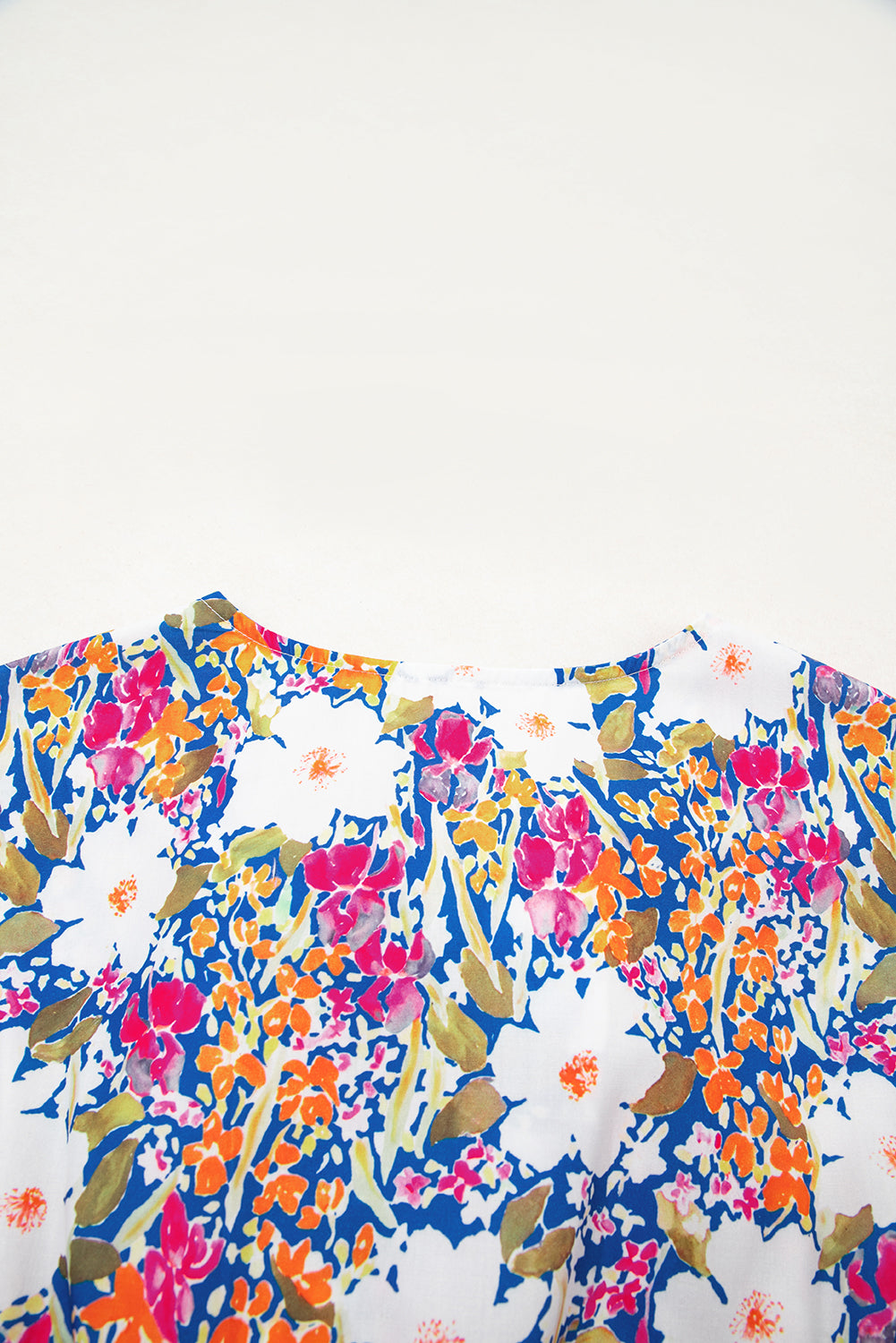 Modern Grace floral print sleeveless peplum blouse with bow applique, slit sleeves, and floral design, perfect for stylish summer wear.