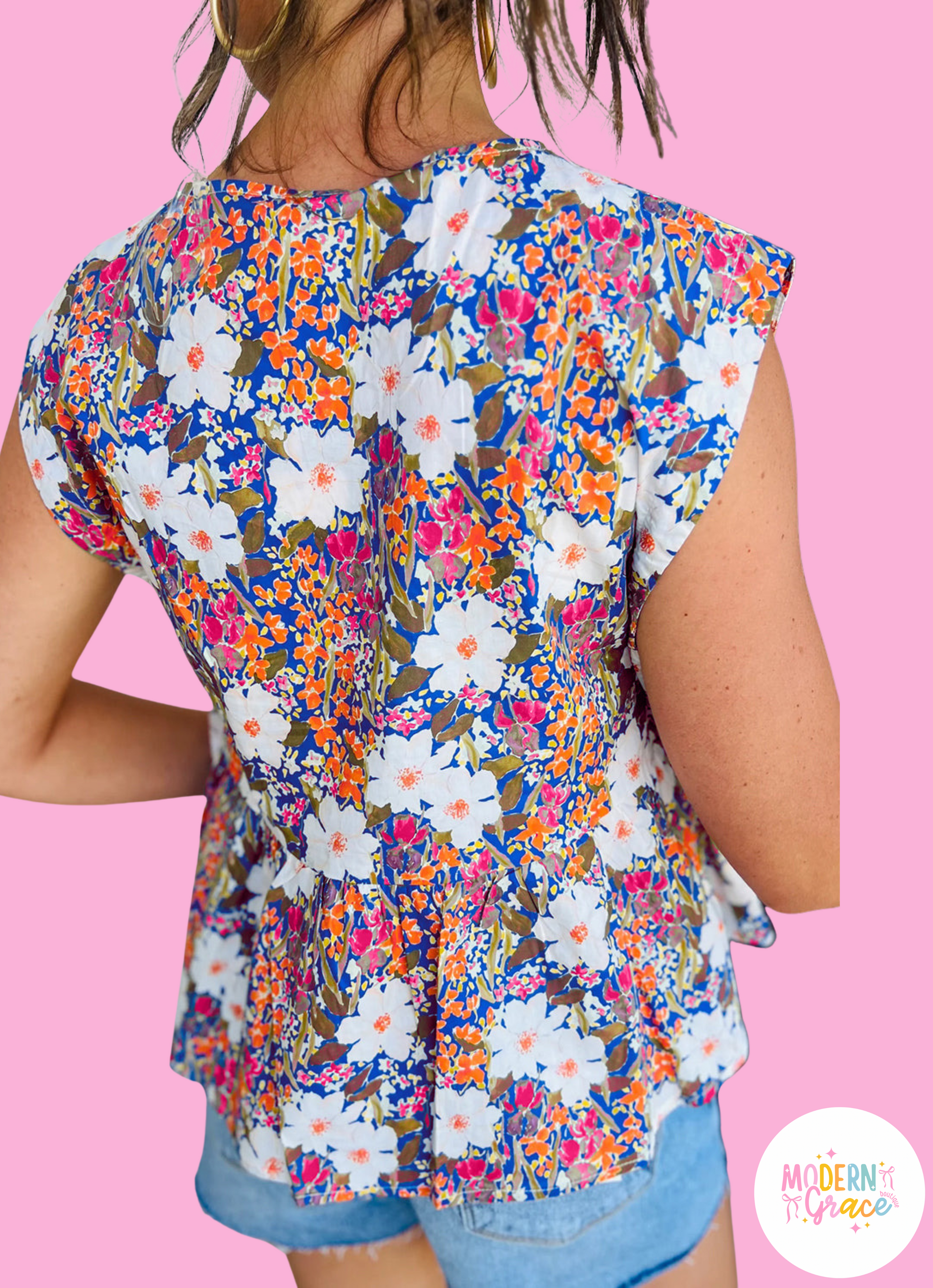 Modern Grace floral print sleeveless peplum blouse with bow applique, slit sleeves, and floral pattern, perfect for stylish summer looks.