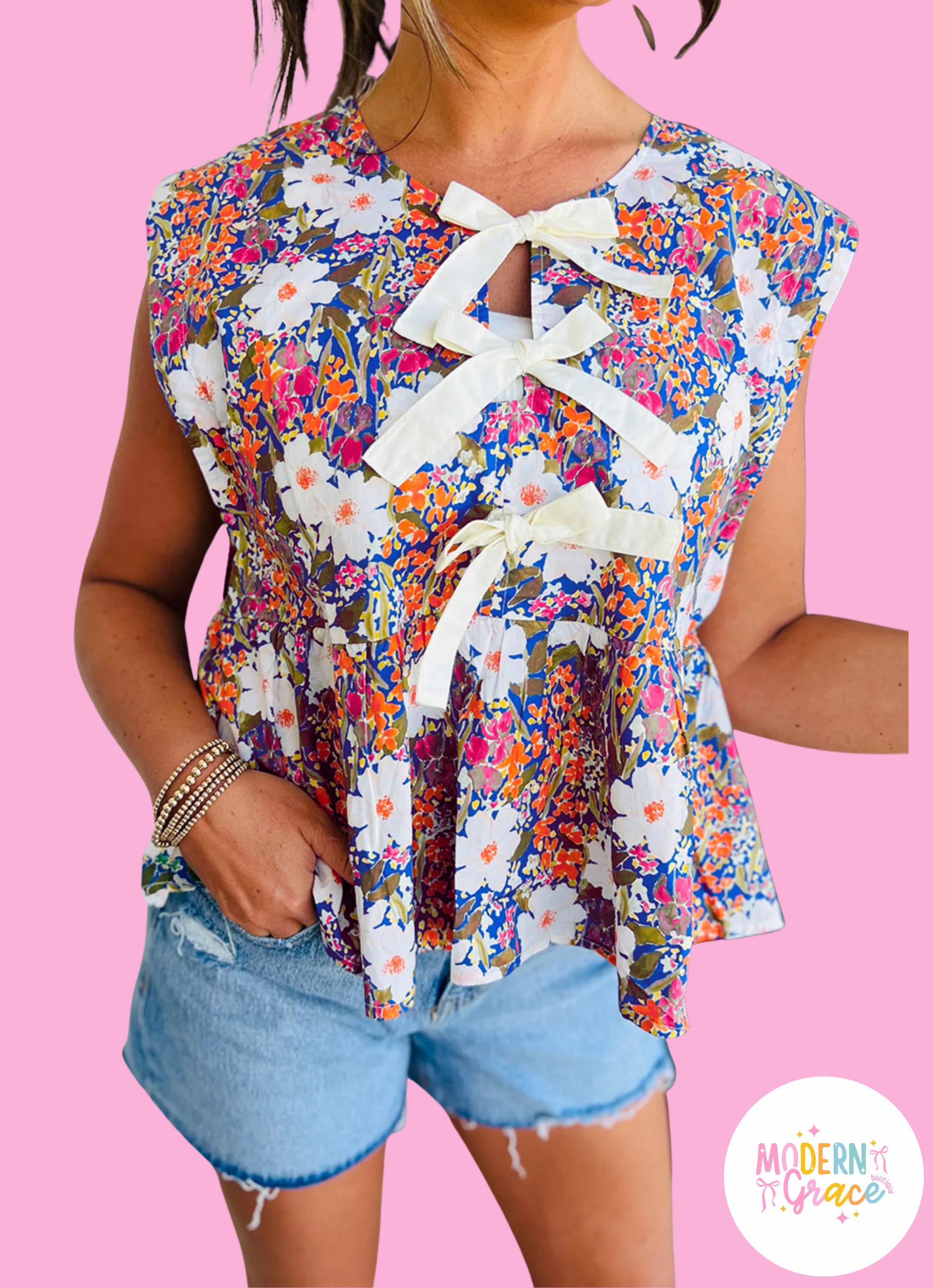 Modern Grace floral print sleeveless peplum blouse with bow applique and slit sleeves, made of polyester, online exclusive.