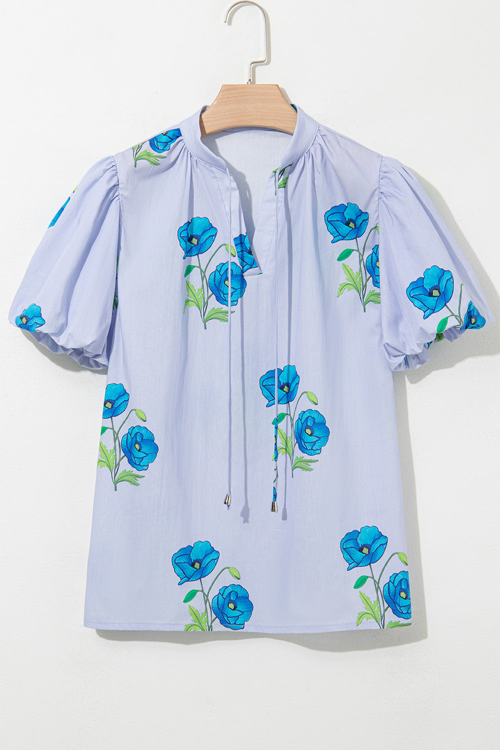 Sky blue floral print tie split neck blouse by Modern Grace with short puff sleeves, made of 100% cotton.