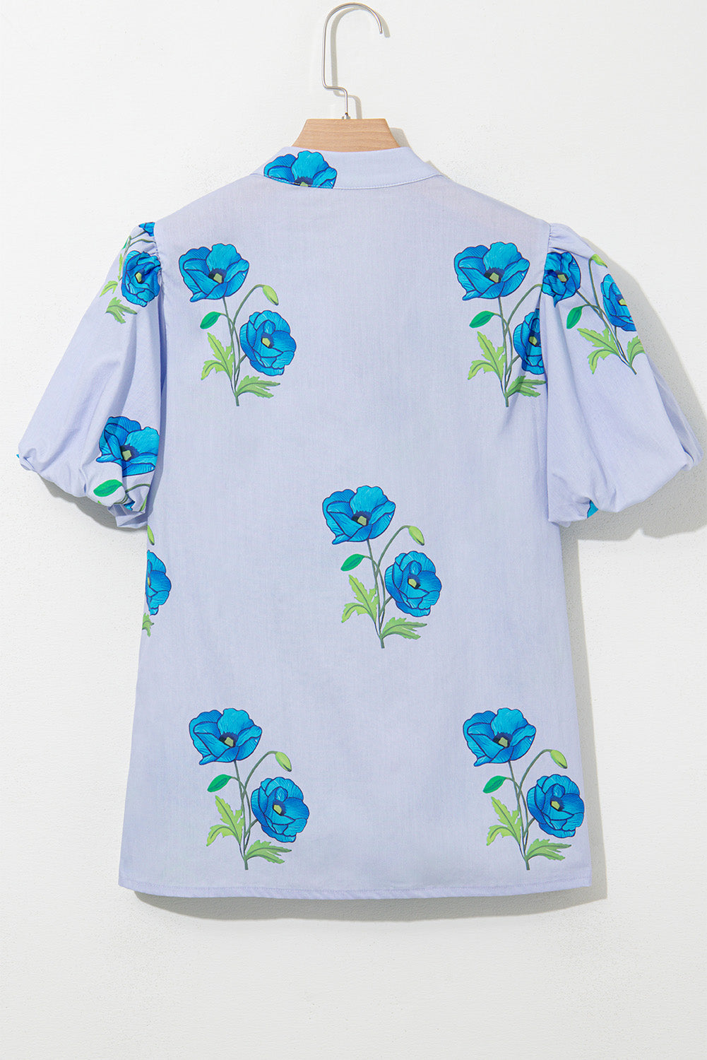Sky blue floral print blouse by Modern Grace with tie front, split neck, short puff sleeves, made of 100% cotton.