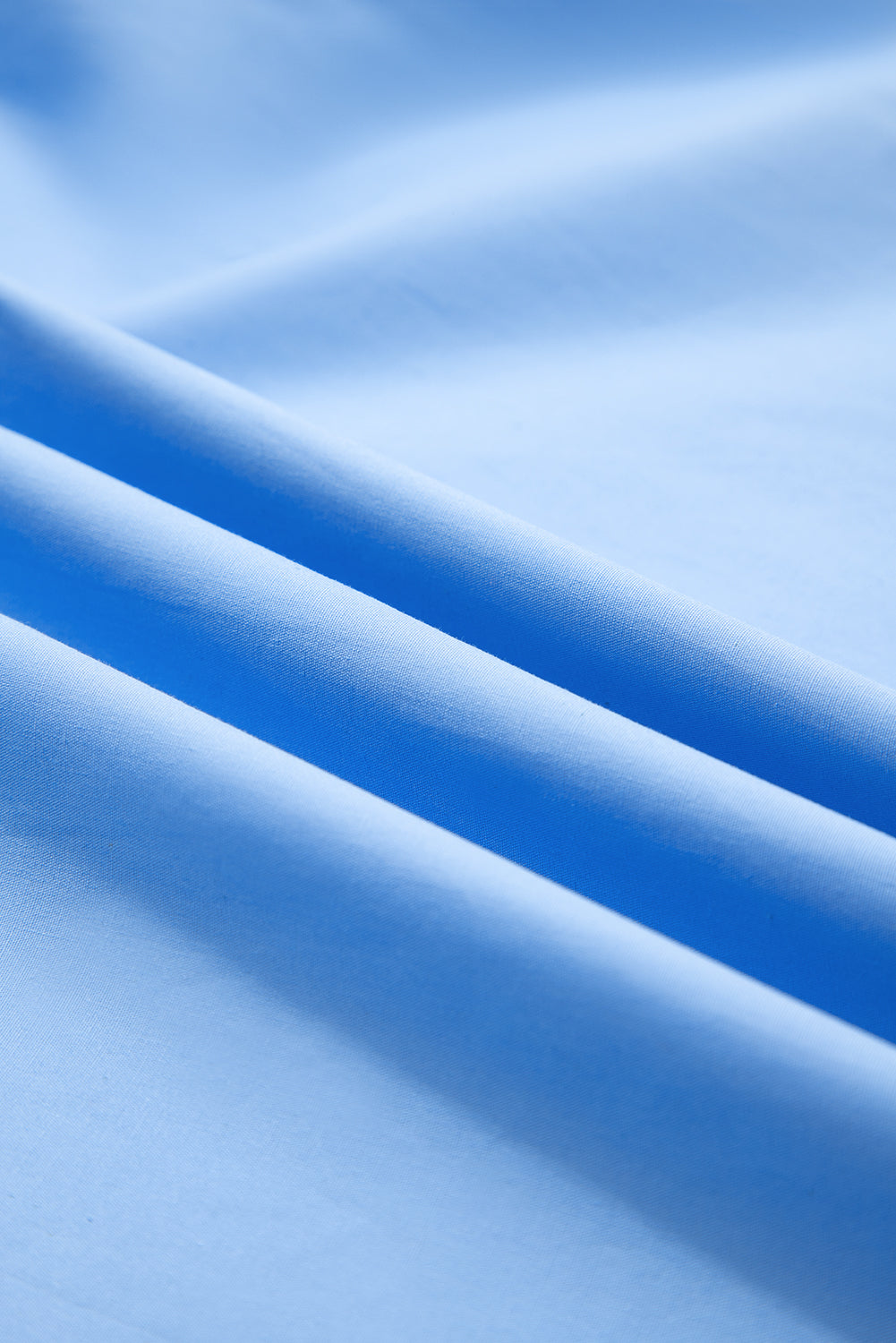 Sky blue striped V-neck blouse with short puff sleeves by Modern Grace, made of 100% cotton, exclusive online.
