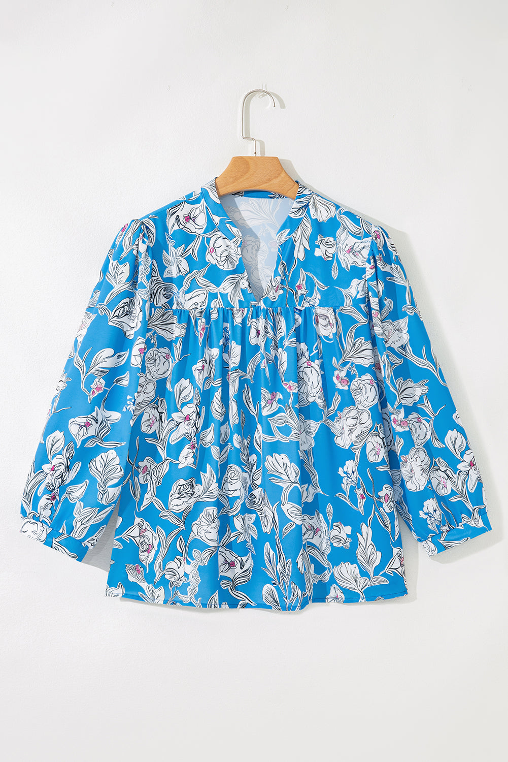 Sky blue floral print V-neck blouse with 3/4 puff sleeves by Modern Grace, featuring a stylish and feminine design.
