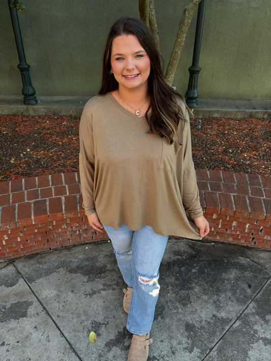 Flowy boho Kaki V-neck oversized top by Modern Grace with relaxed fit and lightweight fabric, shown on a hanger.