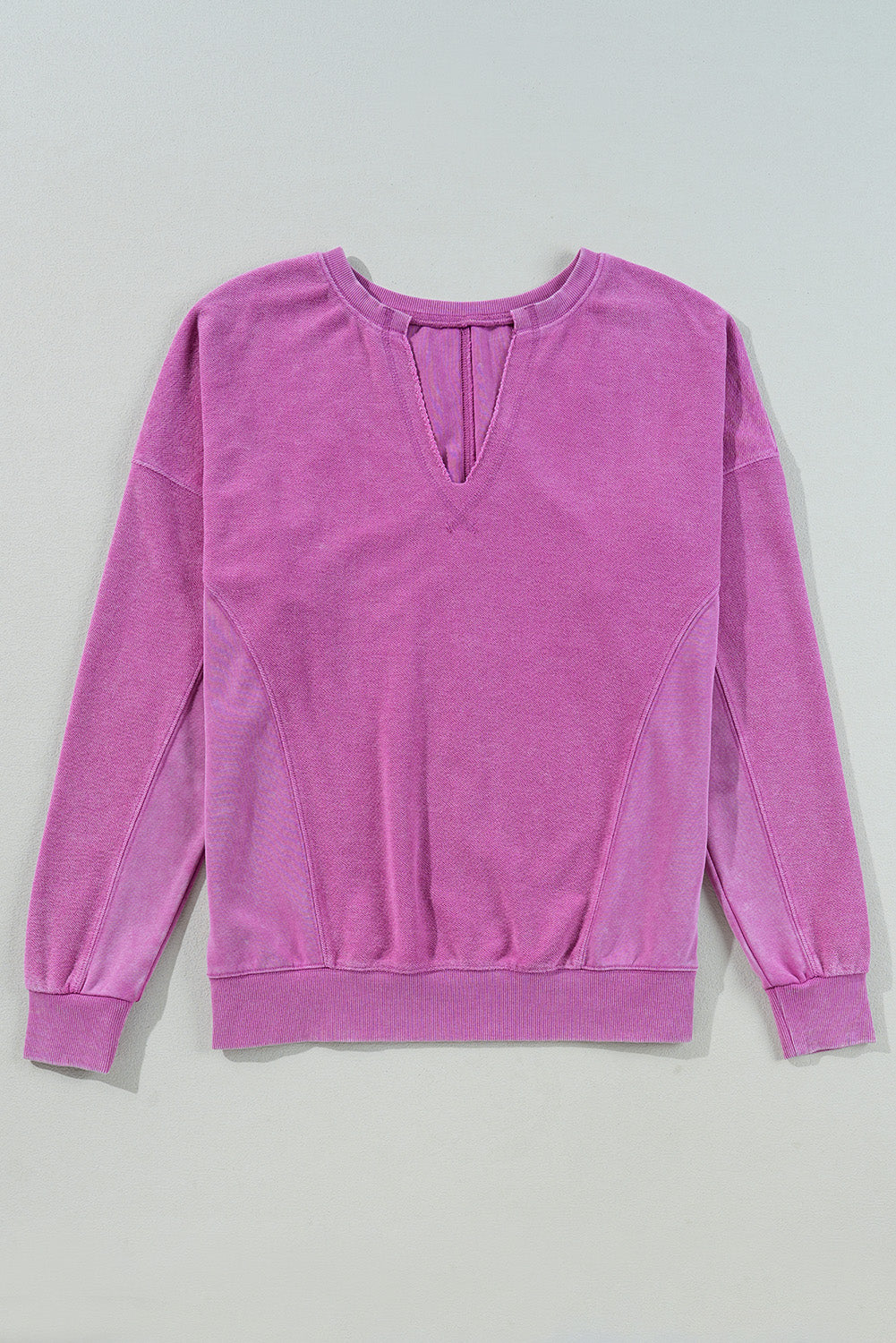 Bright pink Modern Grace sweatshirt with notched neck and drop shoulder design, made of soft solid color fabric.
