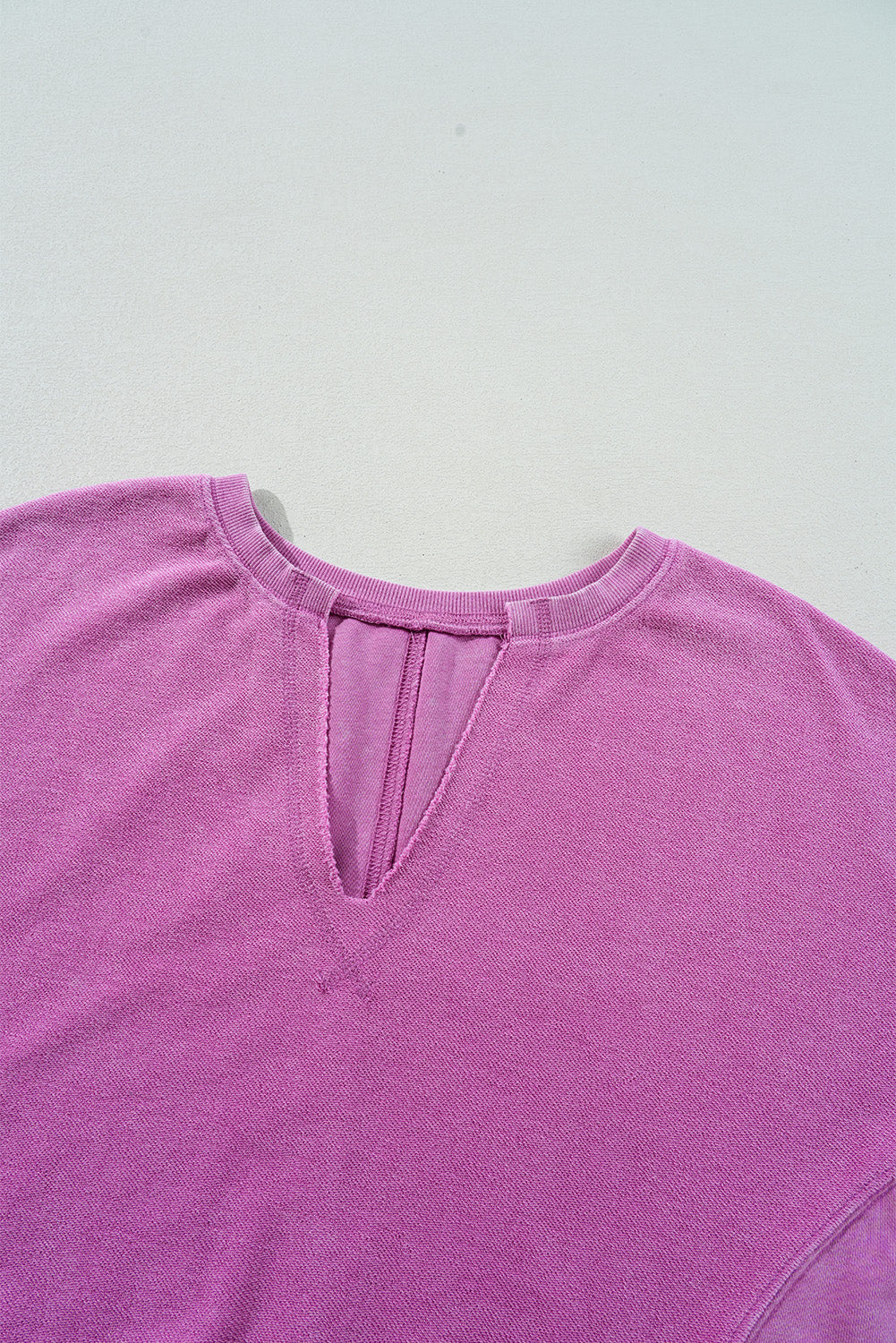 Bright pink solid color sweatshirt with a notched neck and drop shoulder design from Modern Grace, casual top for comfortable style.