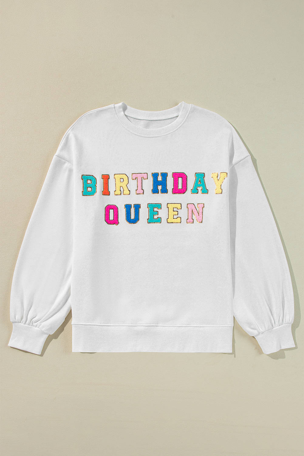 White Birthday Queen graphic sweatshirt with balloon sleeves from Modern Grace, featuring bold birthday-themed text and comfortable fit.
