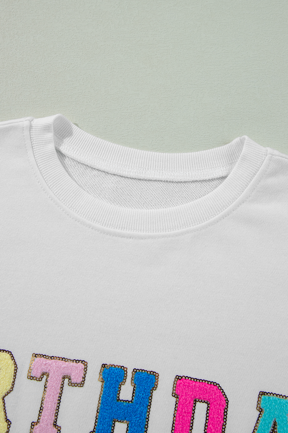 White Birthday Queen graphic sweatshirt with balloon sleeves from Modern Grace, featuring bold birthday-themed design.