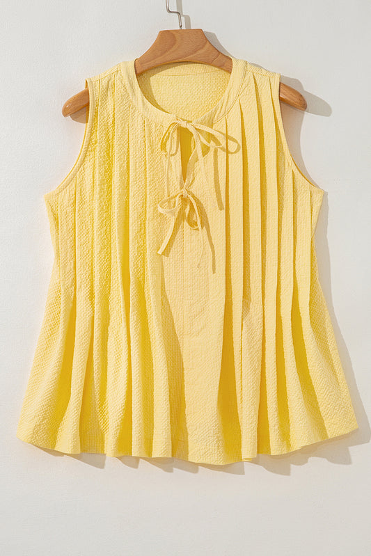 Yellow cream tank top by Modern Grace with a bow tie, notched neckline, and pleated design, made of polyester fabric.
