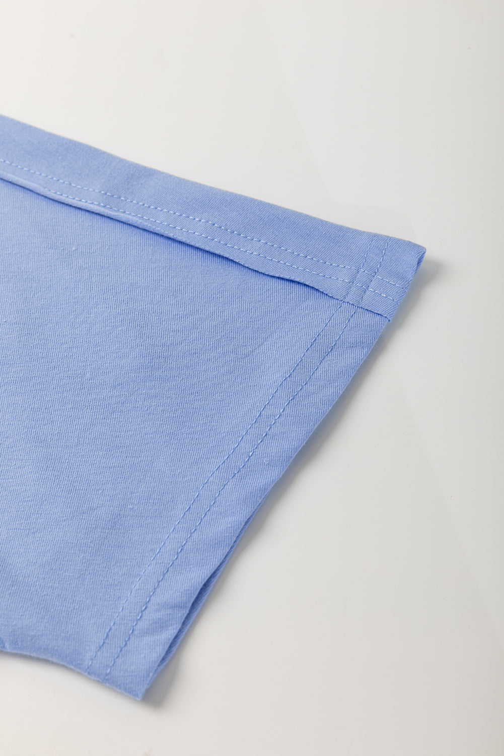 Sky blue loose crew neck T-shirt by Modern Grace featuring flower patches, exposed stitching, and casual fit.