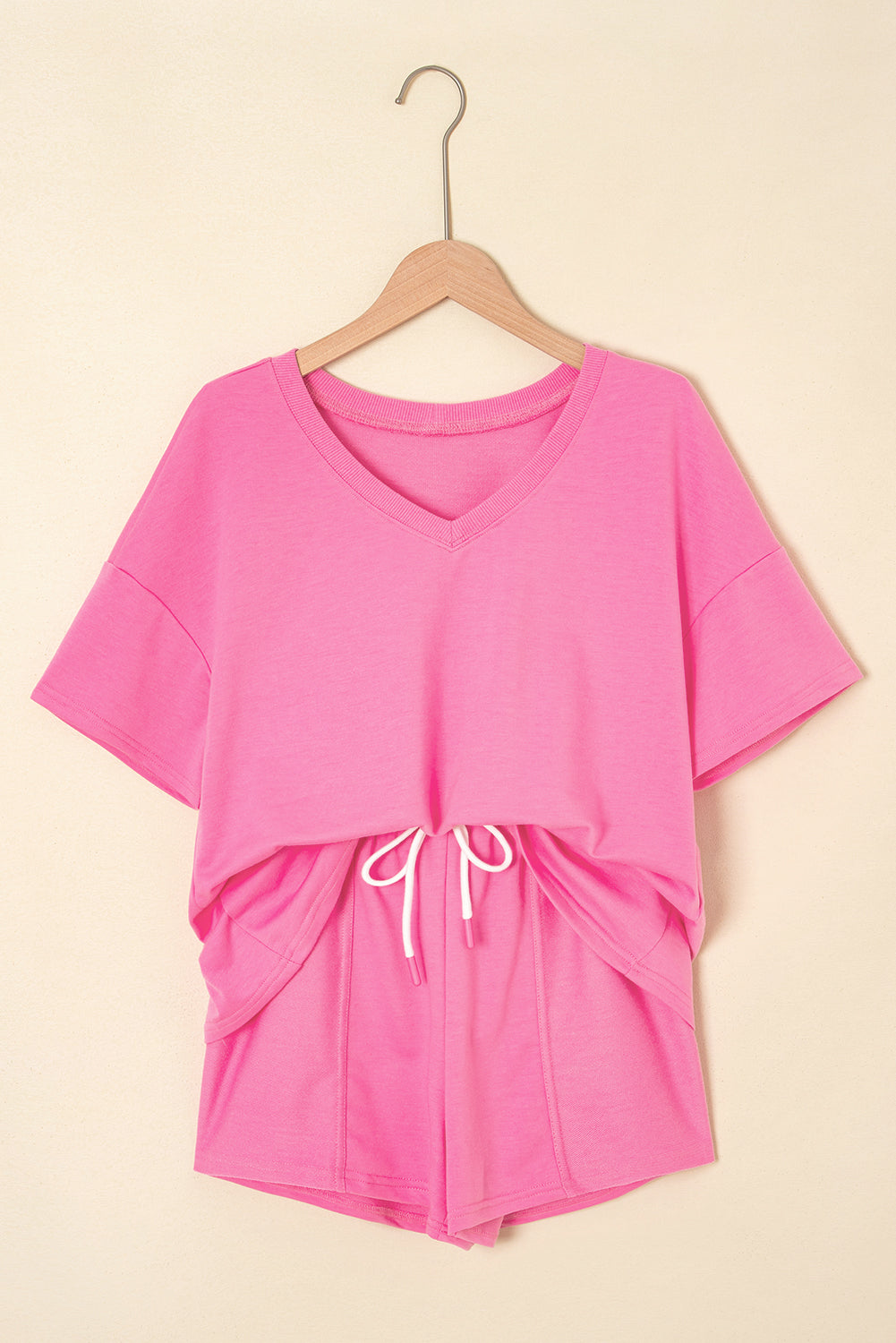 Pink V-neck drawstring shorts set by Modern Grace, two-piece casual outfit with a relaxed fit, perfect for warm weather.