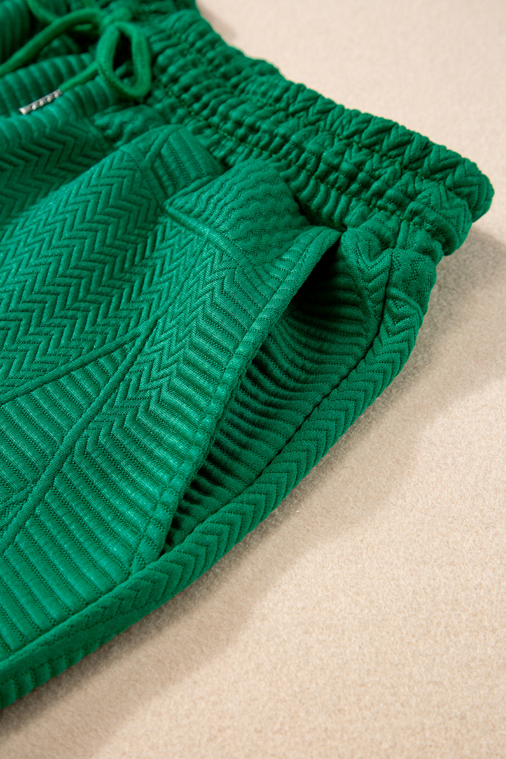 Dark green textured ruffle split top and drawstring shorts set by Modern Grace, two-piece summer outfit with stylish details.