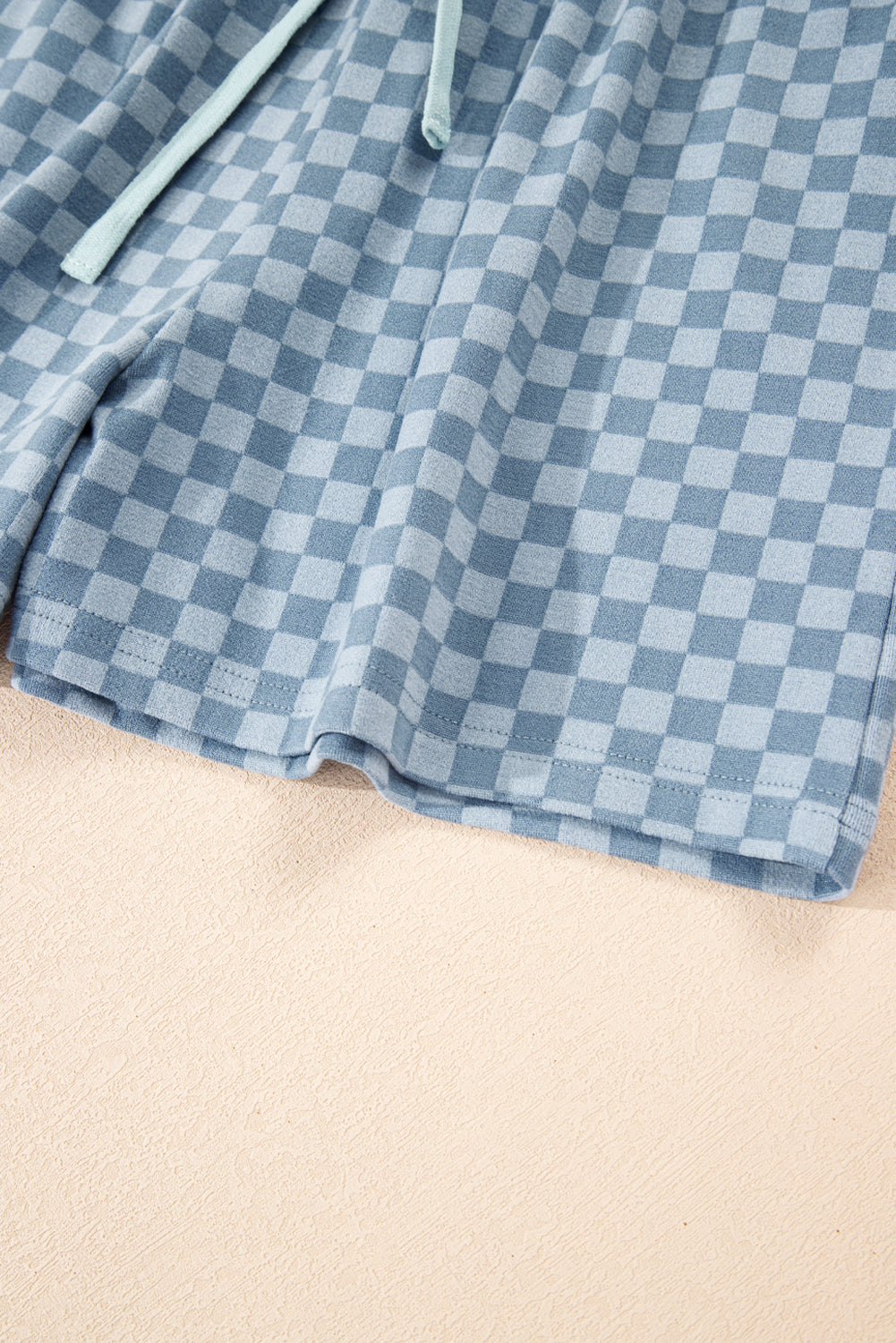 Sky blue checkerboard long sleeve pullover and shorts set by Modern Grace, made from polyester and elastane, with a casual fit.