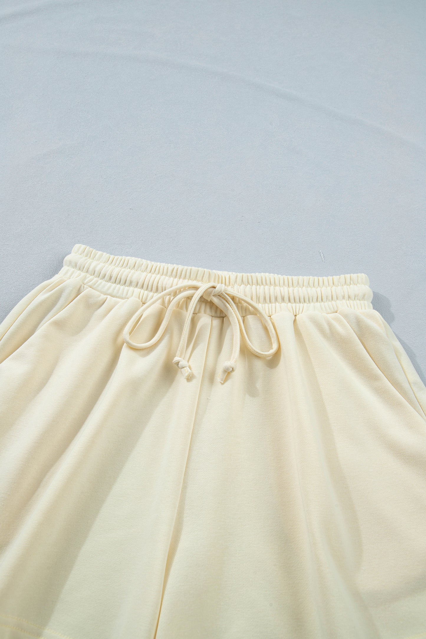 Modern Grace white contrast leopard bow V-neck loose tee with drawstring shorts two-piece set, casual summer outfit.
