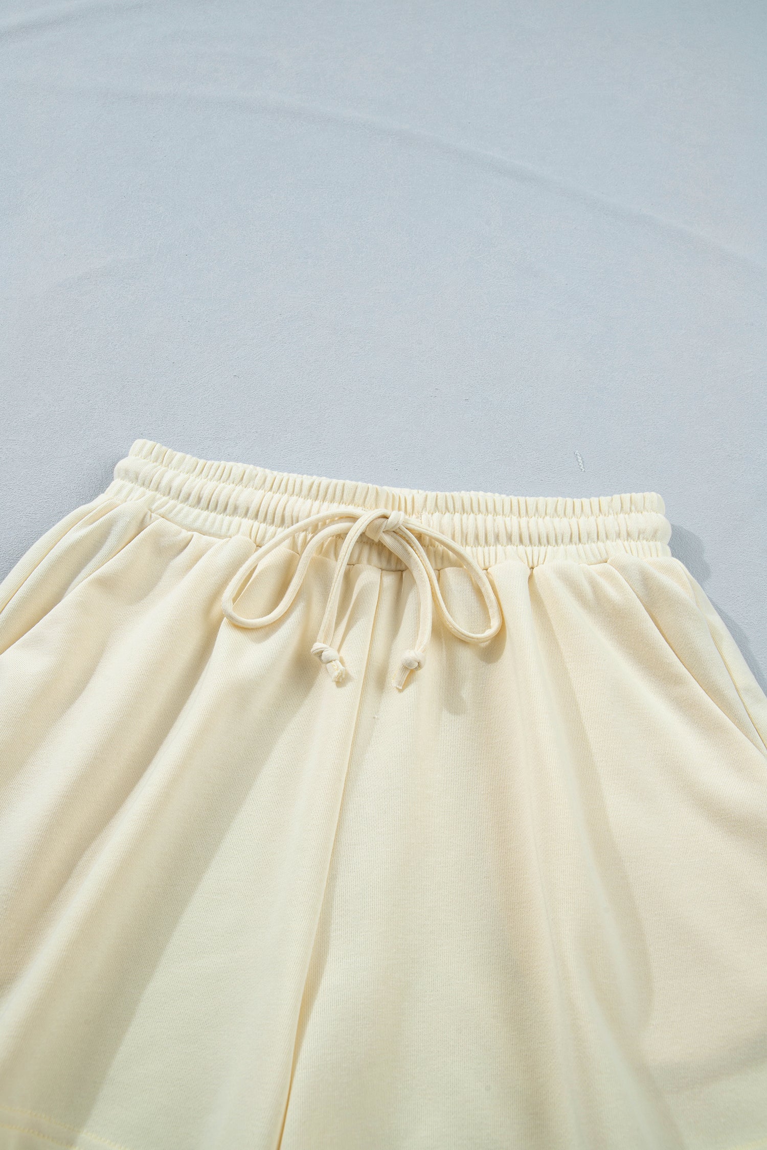 Modern Grace white contrast leopard bow V-neck loose tee with drawstring shorts two-piece set, casual summer outfit.