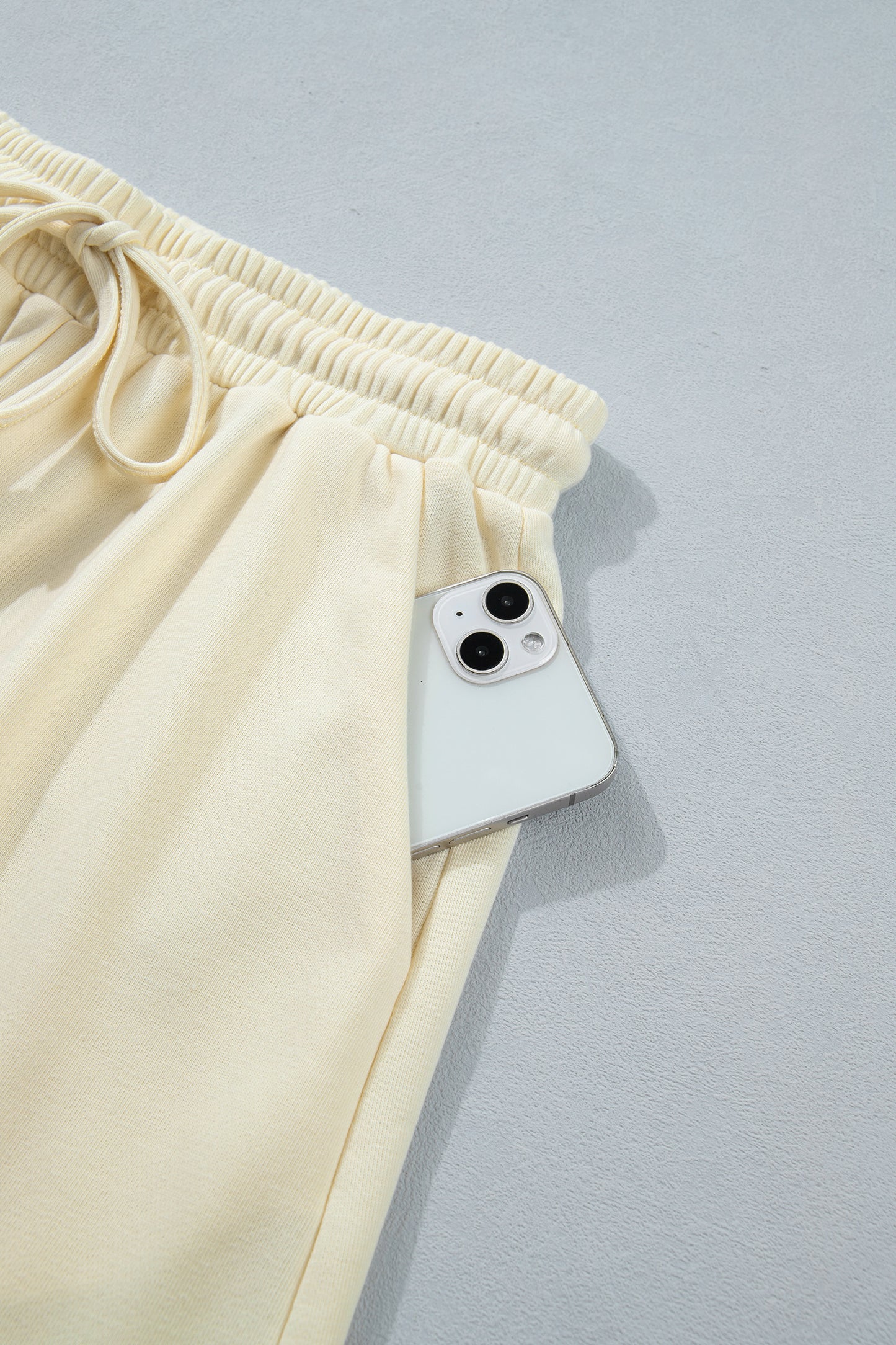 Modern Grace white two-piece set with contrast leopard bow patches, V-neck loose tee, and drawstring shorts, casual summer outfit.