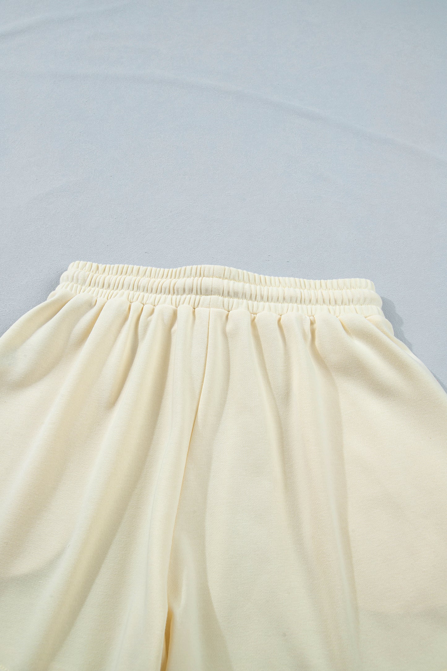 Modern Grace white two-piece set with leopard bow patch, V-neck loose tee, and drawstring shorts, perfect for casual wear.
