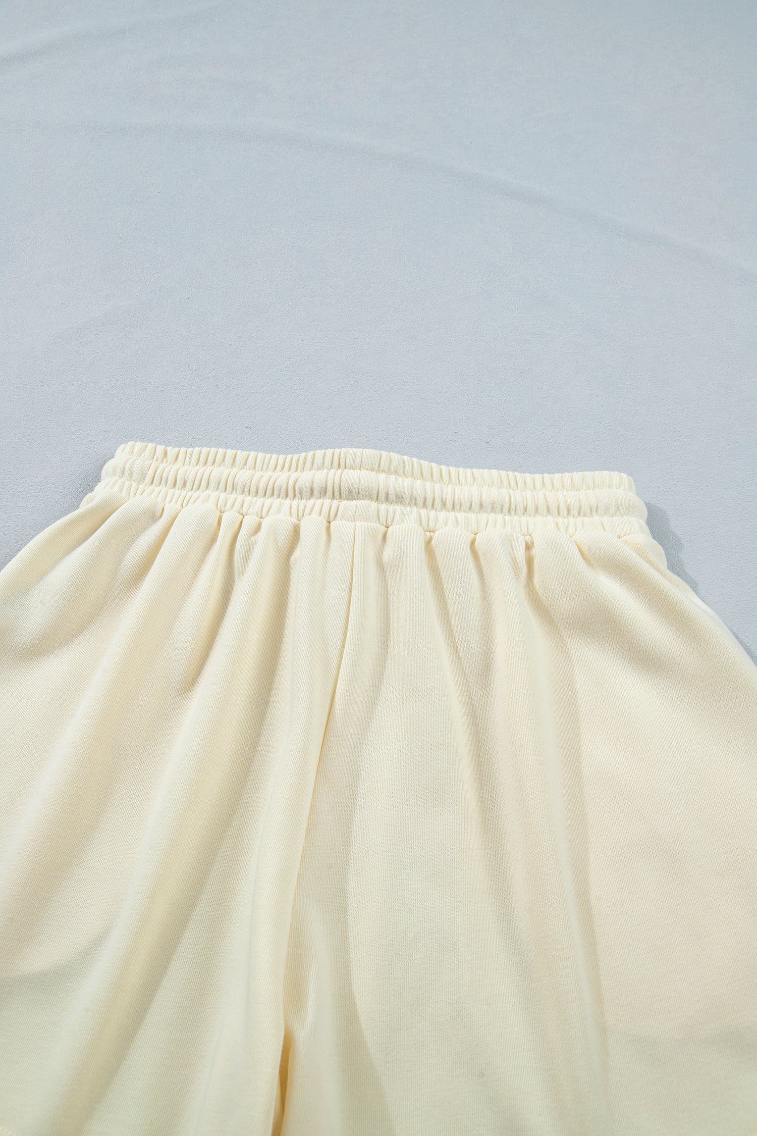 Modern Grace white two-piece set with leopard bow patch, V-neck loose tee, and drawstring shorts, perfect for casual wear.