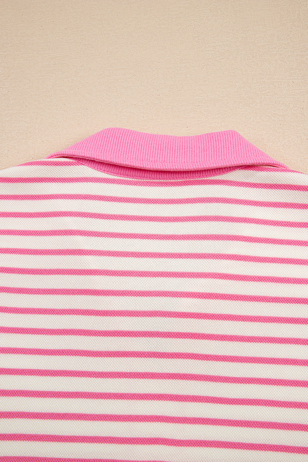 Modern Grace pink stripe two-piece set with collared V-neck pullover and matching skort, featuring drop shoulder design.