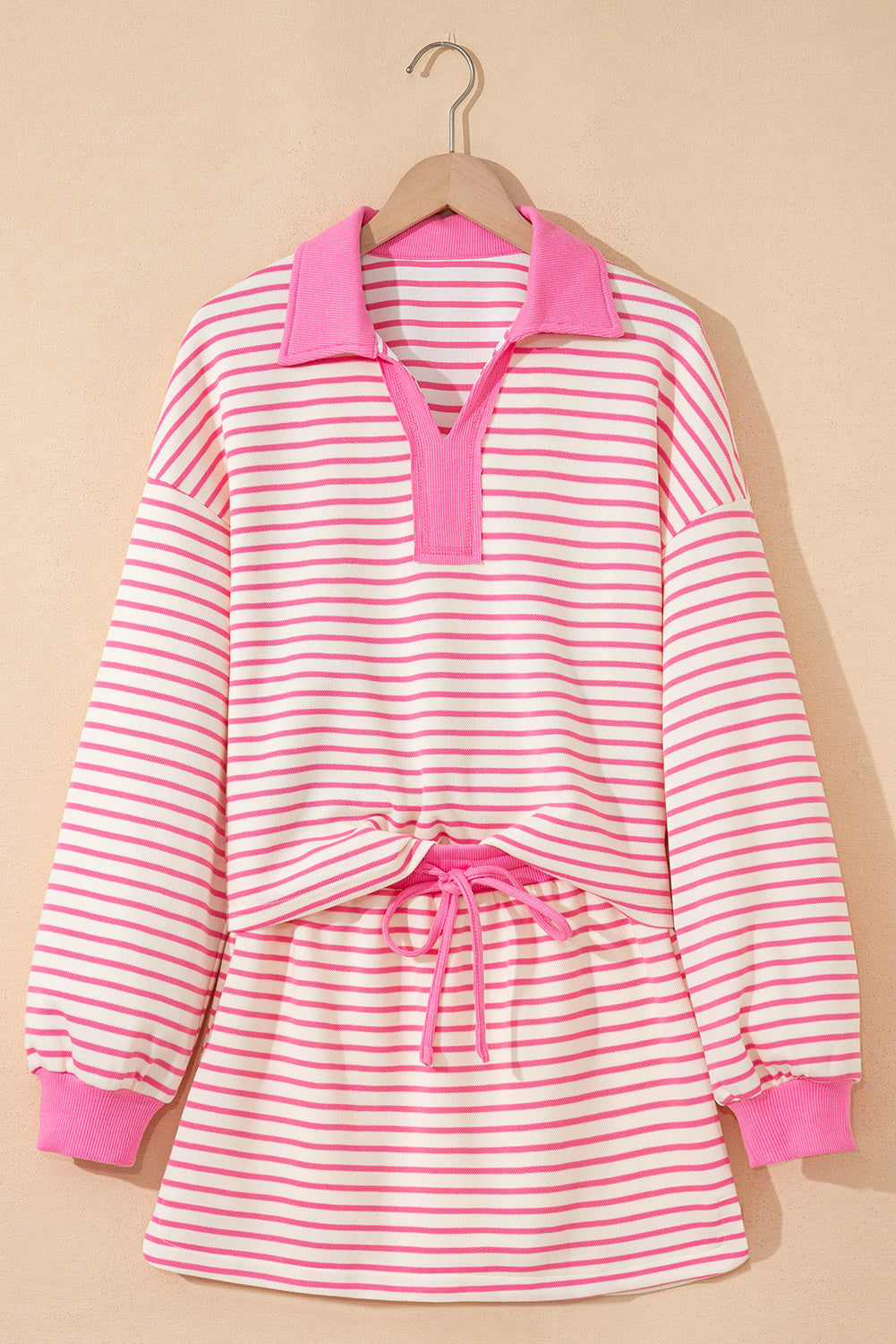 Modern Grace pink stripe two-piece outfit featuring a collared V-neck pullover and matching skort, perfect for casual wear.