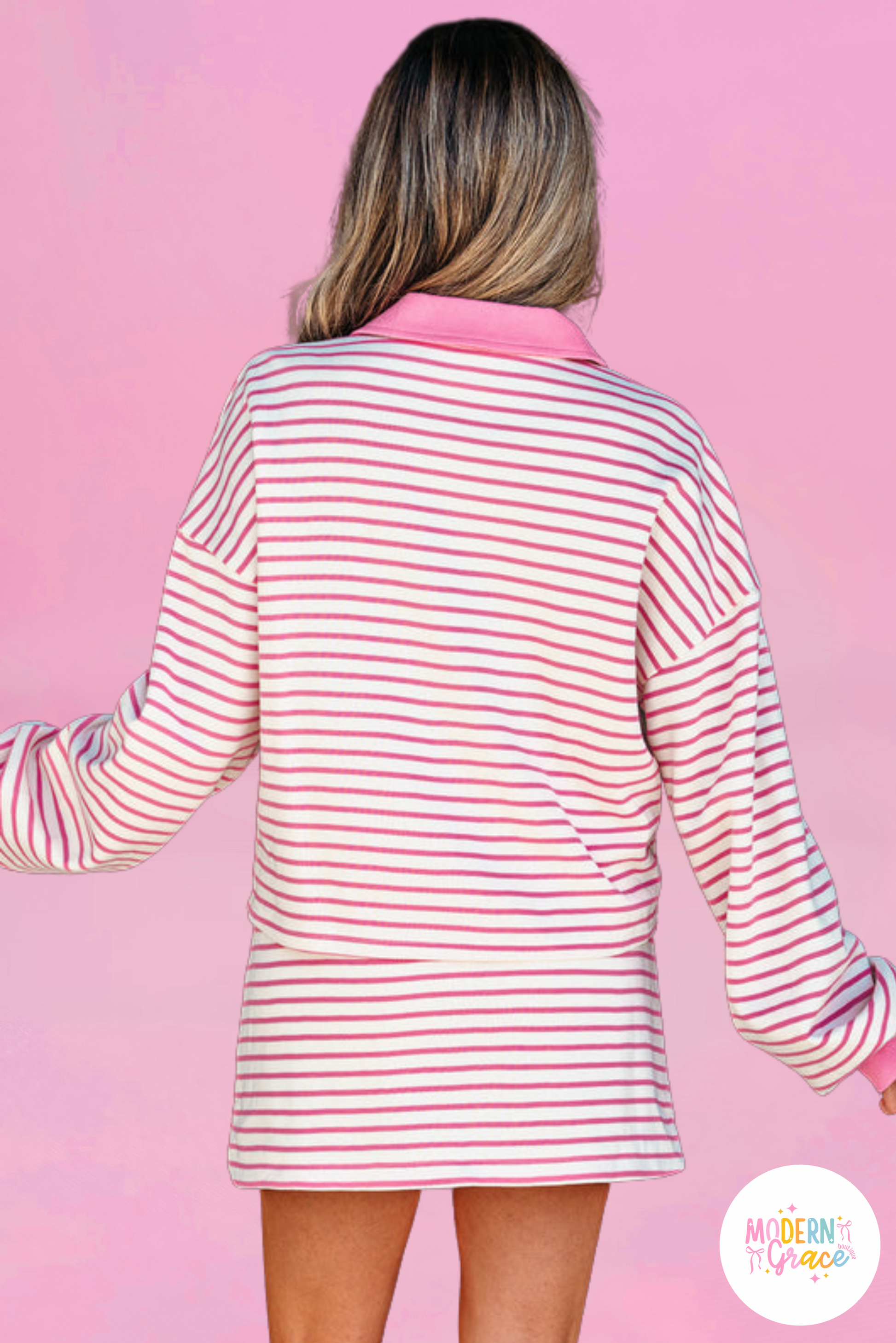Modern Grace pink stripe two-piece outfit with collared V-neck pullover and skort, featuring drop shoulder design, polyester-cotton blend.