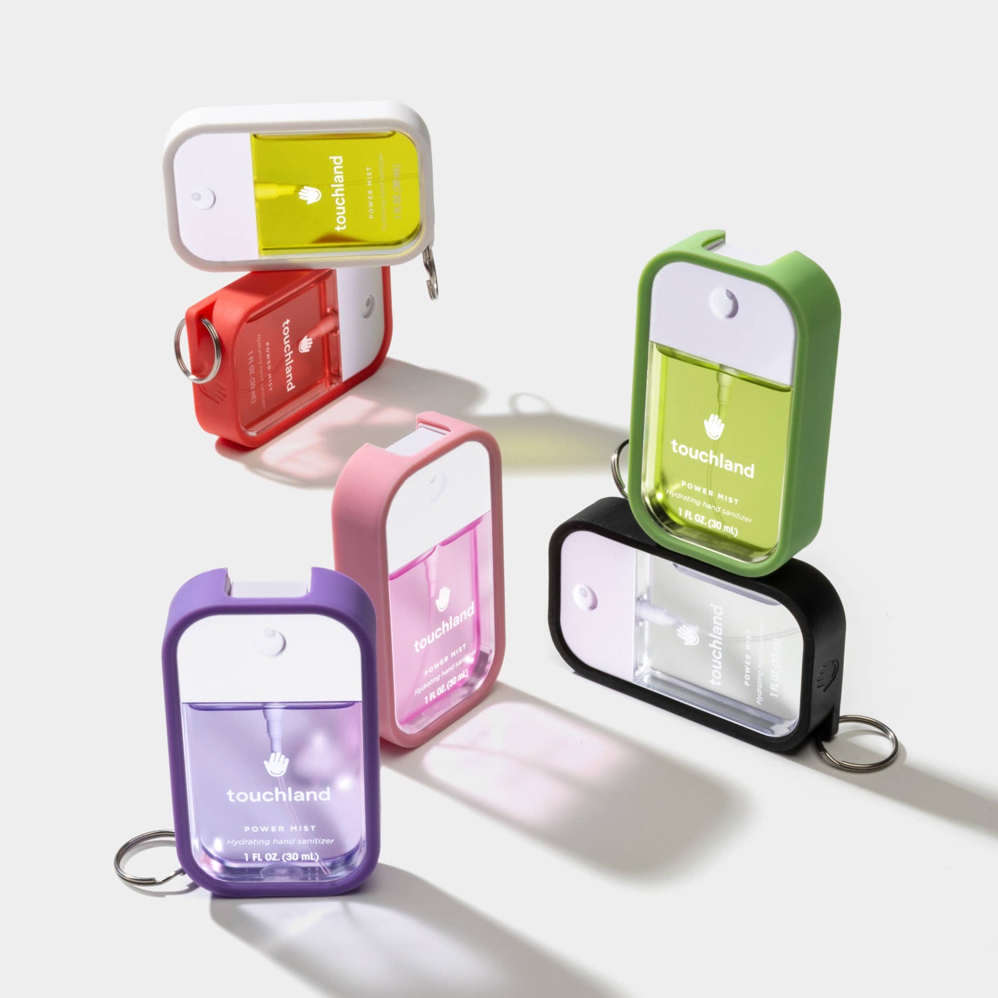 Pink bubblegum hand mist case by Touchland, soft silicone cover with textured surface, designed to hold a hand sanitizer spray.